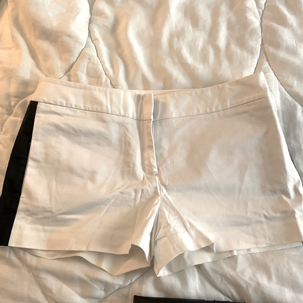 White shorts with a black stripe on each side mid thigh